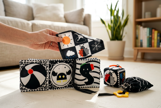 AI-generated adult hand presenting high-contrast fabric baby toys on a floor play mat